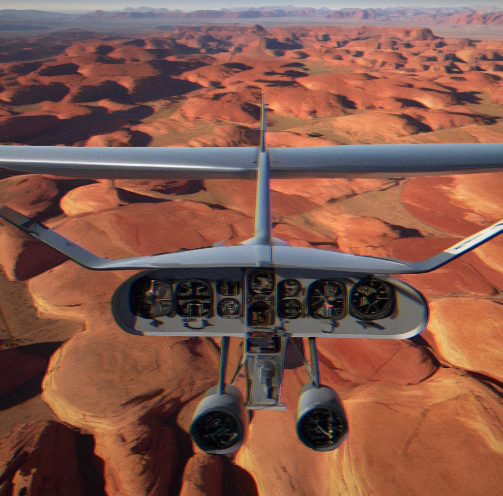 Shadow of aircraft moving across red rock formations with parallel ridges creating geometric patterns