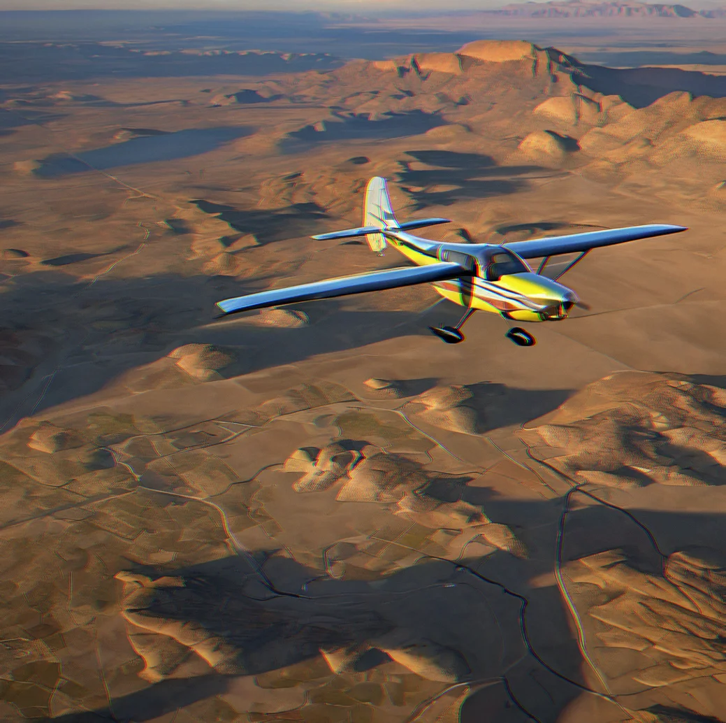 Dawn light across high desert basin with buttes casting long shadows and aircraft banking toward distant mountain pass at 8,500 feet