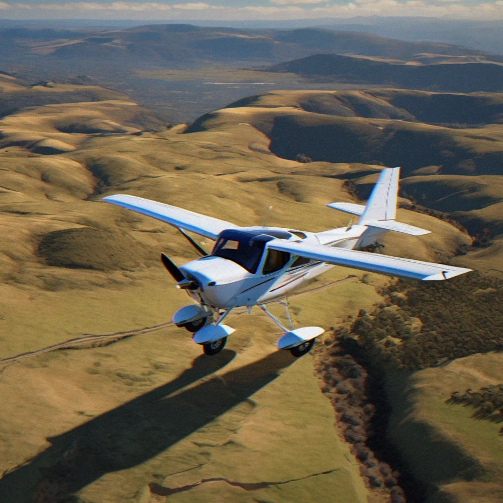 Overhead view of single-engine aircraft casting shadow on terrain during low-altitude flight